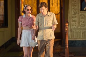 A still from "Cafe Society" showing Kristen Stewart in custom-made white silk Chanel shorts alongside Jesse Eisenberg